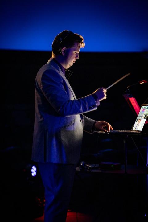 David Ibbett holding a conducting baton