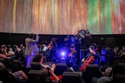 David Ibbett conducting for Black Hole Symphony at the Museum of Science