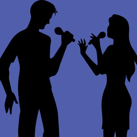 a duo sings with microphones in front of a purple background