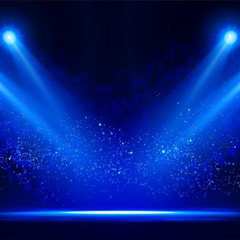 a stage with spotlights shining down 